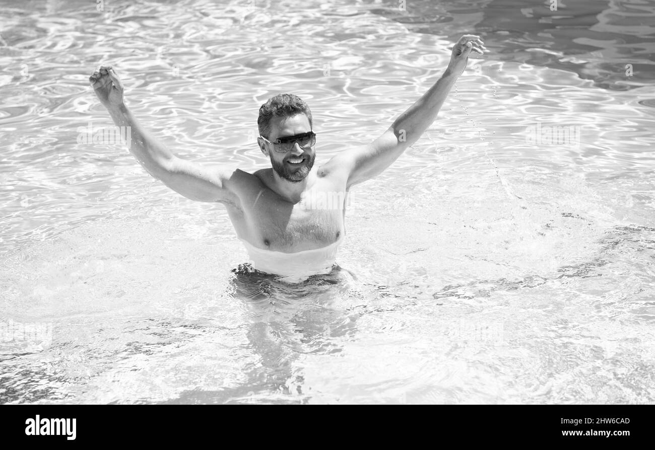 happy bearded man in sunglasses have fun in swimming pool water on summer holidays, summer vacation. Stock Photo