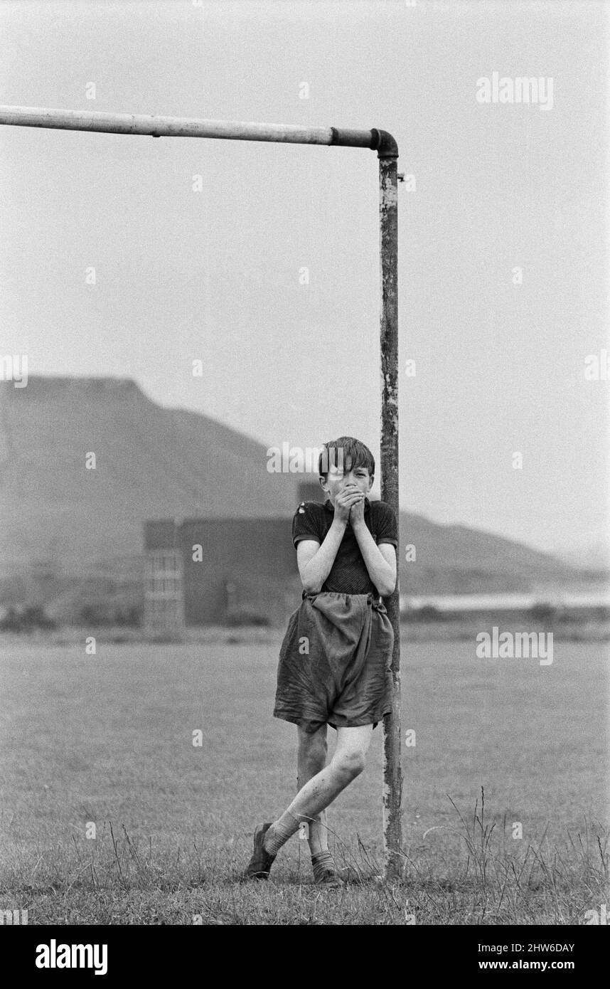 David Bradley, (aged 14) playing the part of Billy Casper, pictured with his Kestral, on the film set of the film Kes.   Here Billy Casper is playing the goalkeeper in the school football match scene.  Kes is a 1969 release drama film directed by Ken Loach and produced by Tony Garnett. The film is based on the 1968 novel A Kestrel for a Knave, written by the Barnsley-born author Barry Hines. The film is ranked seventh in the British Film Institute's Top Ten (British) Films and among the top ten in its list of the 50 films you should see by the age of 14.     The film was shot on location aroun Stock Photo