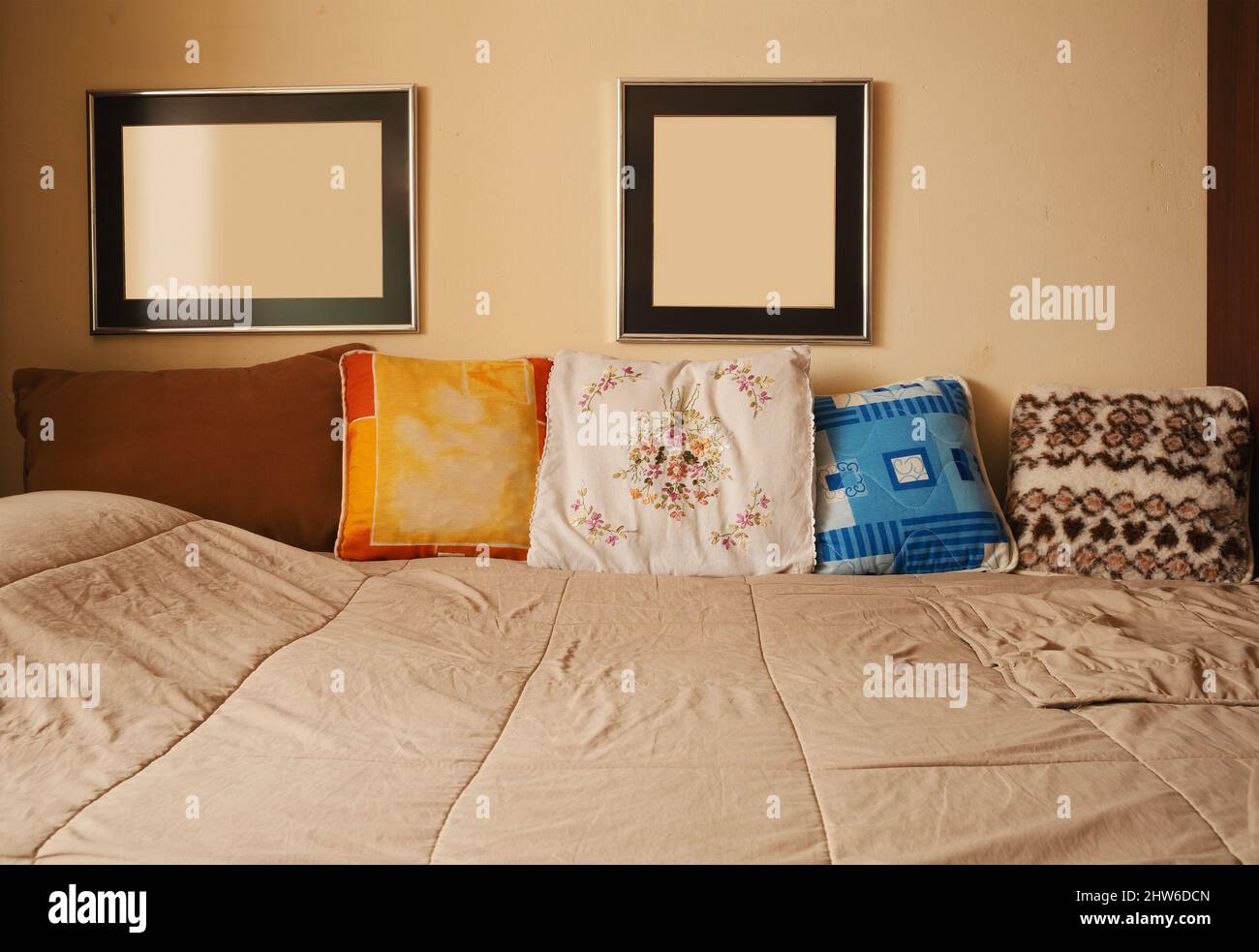 Details of an old bed with decorative pillows, ordinary look of a home from Balkans from 80's. Stock Photo
