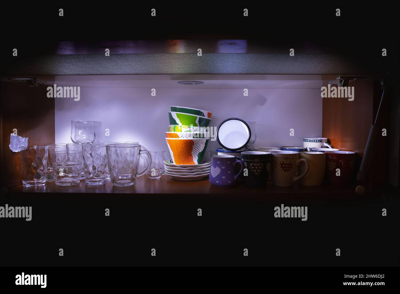 Bunch of clean glasses and cups in cabinet Stock Photo - Alamy