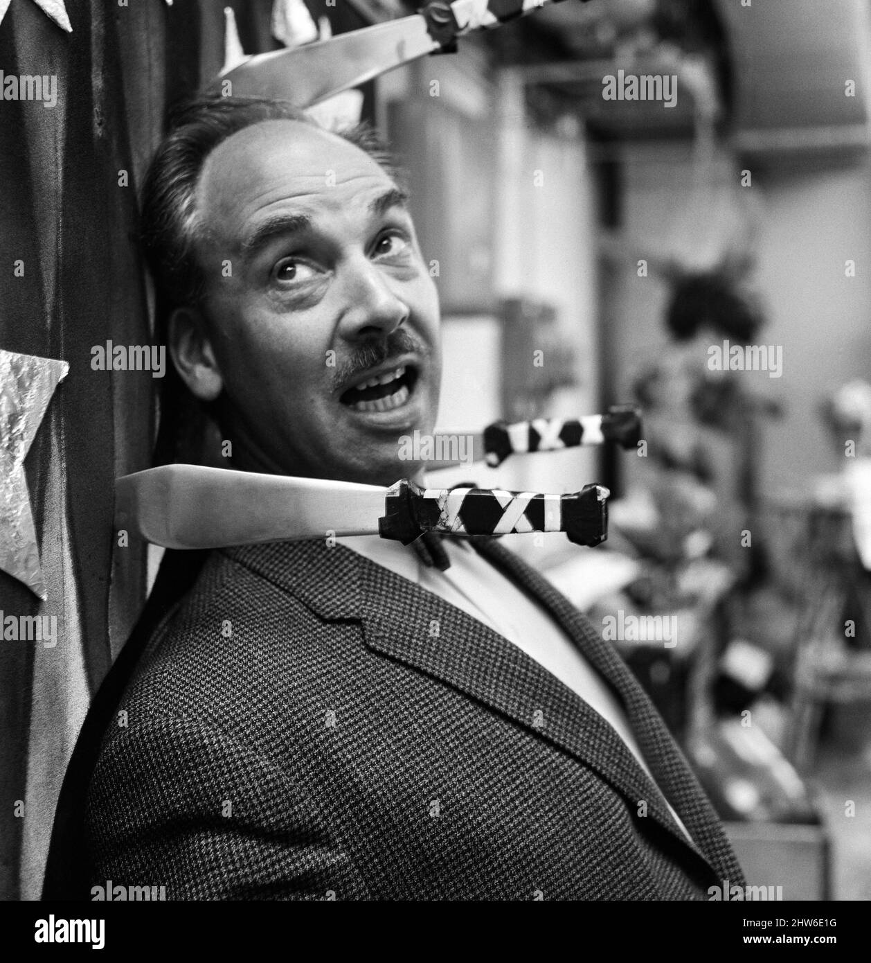 Bernard Wilkie, Senior Designer at the Special Effects Department at BBC television Centre, tries out one of his department's special effects made for a knife throwing routine. 16th May 1968. Stock Photo