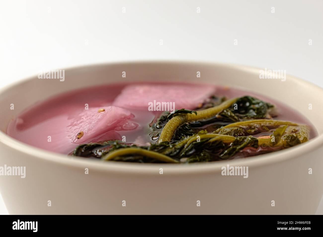 red mustard greens watery Kimchi on a white background Stock Photo Alamy