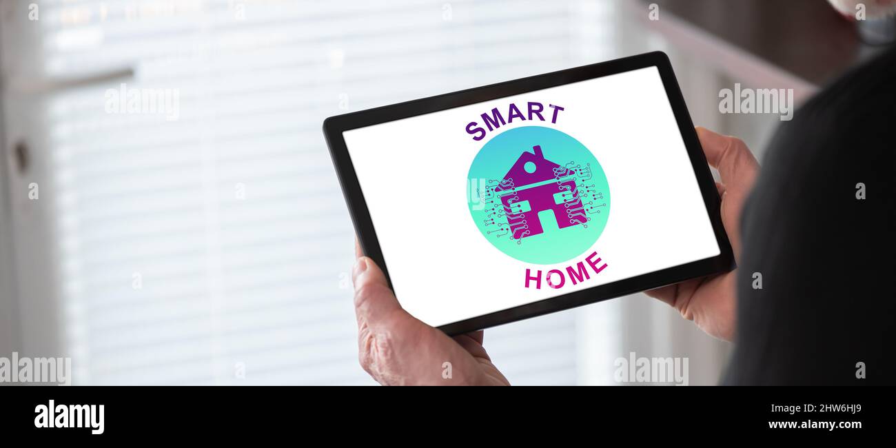 Smart home concept shown on a tablet held by a man Stock Photo