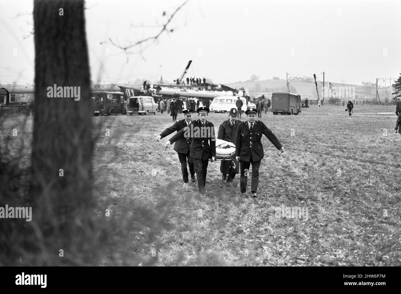 A victim of the Hixon rail disaster is stretchered away from the crash site to a waiting ambulance. The accident occurred after a Inter-City train which crashed into a giant transformer on the level crossing at Hixon near Stafford on Saturday (6-1-68). In the crash eleven people were killed and forty injured. 6th January 1968 Stock Photo