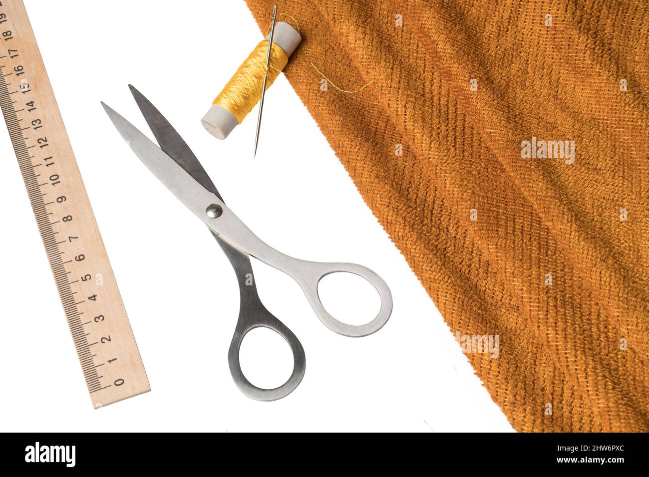 tools and material for sewing, thread, needle, scissors fabric Stock Photo