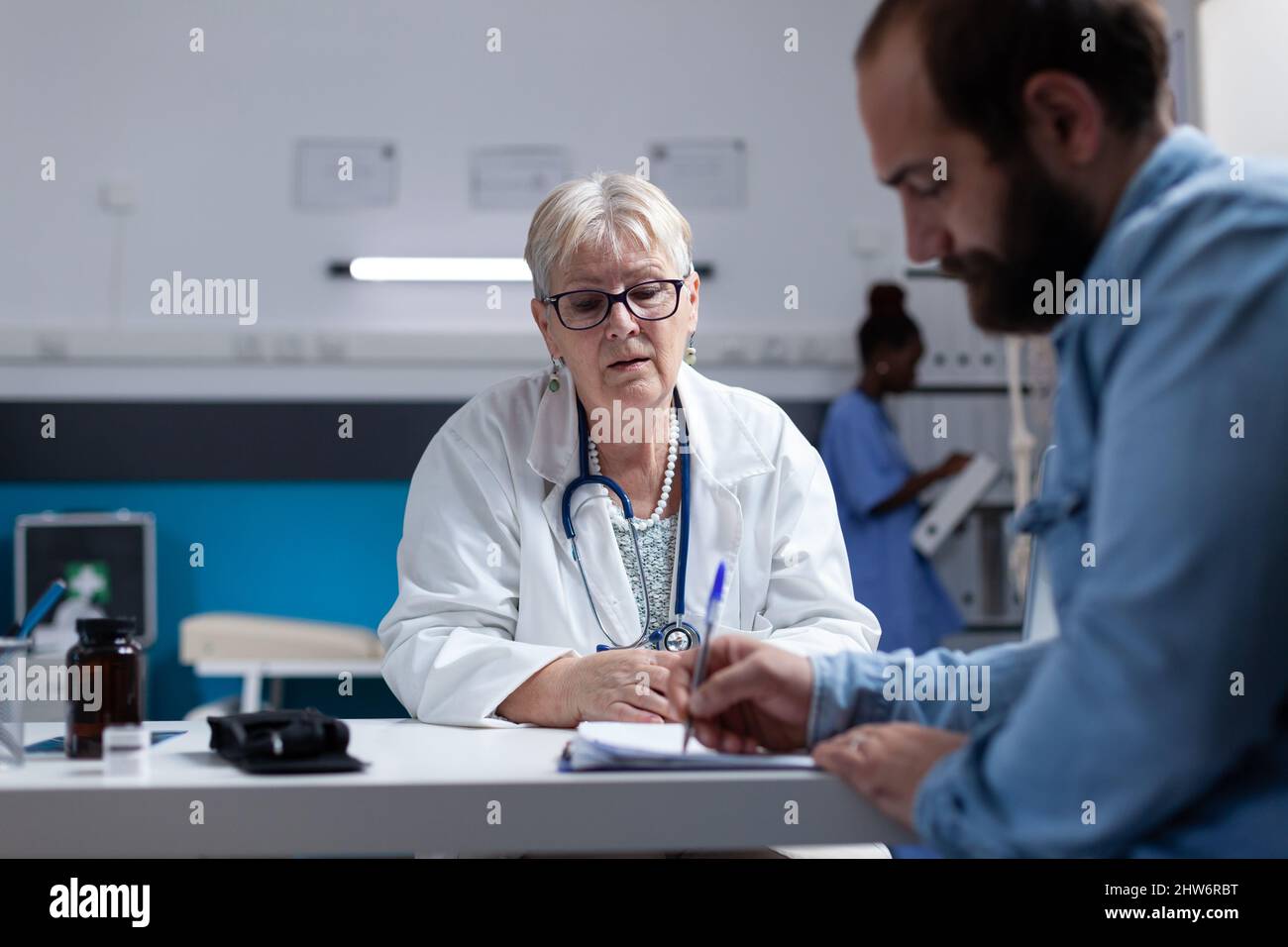 Doctor giving patient documents hi-res stock photography and images - Alamy