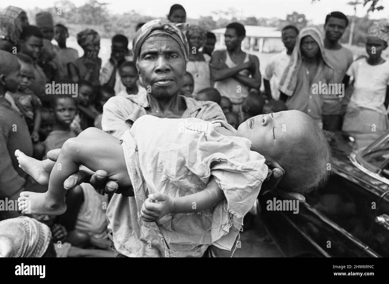 A mother seen here holding the dead body of her baby girl, just one of the estimated one to two million victims of the Biafran War. 23rd June 1968The Nigerian Civil War, also known as the Biafran War endured for two and a half years, from  6 July 1967 to 15 January 1970, and was fought to counter the secession of Biafra from Nigeria. The indigenous Igbo people of Biafra felt they could no longer co-exist with the Northern-dominated federal government following independence from Great Britain. Political, economic, ethnic, cultural and religious tensions finally boiled over into civil war follow Stock Photo