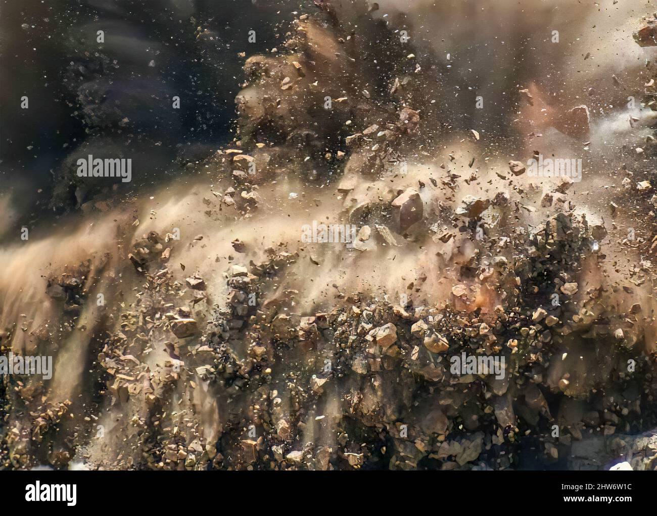 Rock particles and dust clods during dynamite blast on the mining site ...