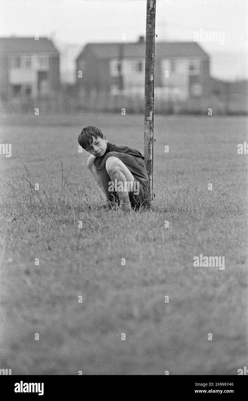 David Bradley, (aged 14) playing the part of Billy Casper, pictured with his Kestral, on the film set of the film Kes.   Here Billy Casper is playing the goalkeeper in the school football match scene.  Kes is a 1969 release drama film directed by Ken Loach and produced by Tony Garnett. The film is based on the 1968 novel A Kestrel for a Knave, written by the Barnsley-born author Barry Hines. The film is ranked seventh in the British Film Institute's Top Ten (British) Films and among the top ten in its list of the 50 films you should see by the age of 14.     The film was shot on location aroun Stock Photo