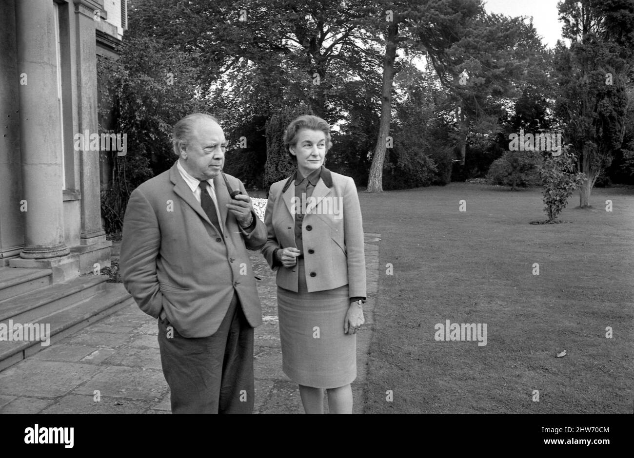 Novelist J. B. Priestley in the garden of his home with his wife Jacquetta Hawkes at Kissing Tree House in the village of Alveston near Stratford.21st October 1968 Stock Photo