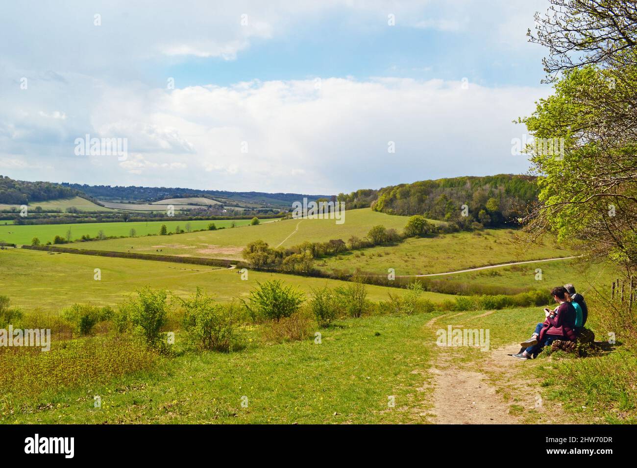 People sitting on a bench at a viewpoint on the Chiltern Hills in Bradenham, Buckinghamshire, England, UK Stock Photo