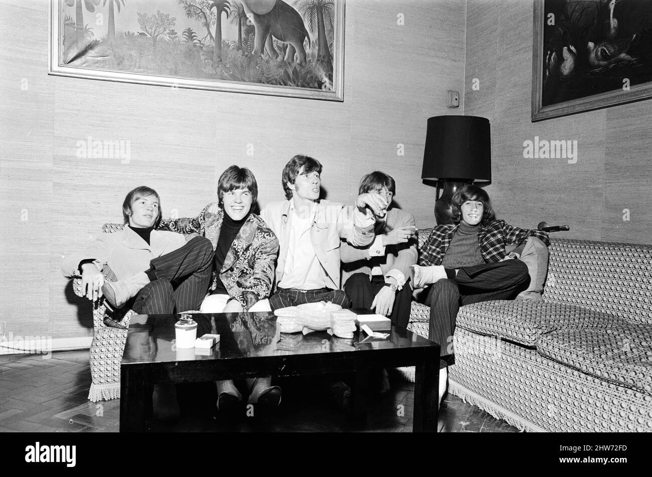 The Bee Gees seen here watching television in their hotel room 17th October 1967.   The Bee Gees is a 5 member group, comprising of Barry Gibb, Maurice Gibb, Robin Gibb, Colin Peterson & Vince Melouney *** Local Caption *** Colin Peterson  Vince Melouney Stock Photo
