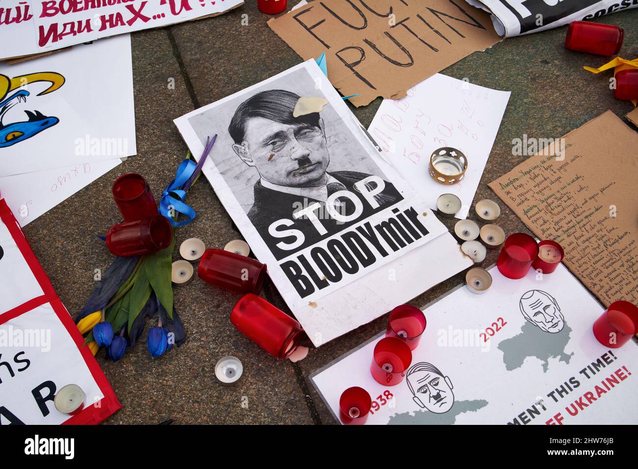 PRAGUE, CZECH REPUBLIC - MARCH 3, 2022: Signs supporting Ukraine and depicting Russian president Vladimir Putin as Adolf Hitler at the base of the mon Stock Photo