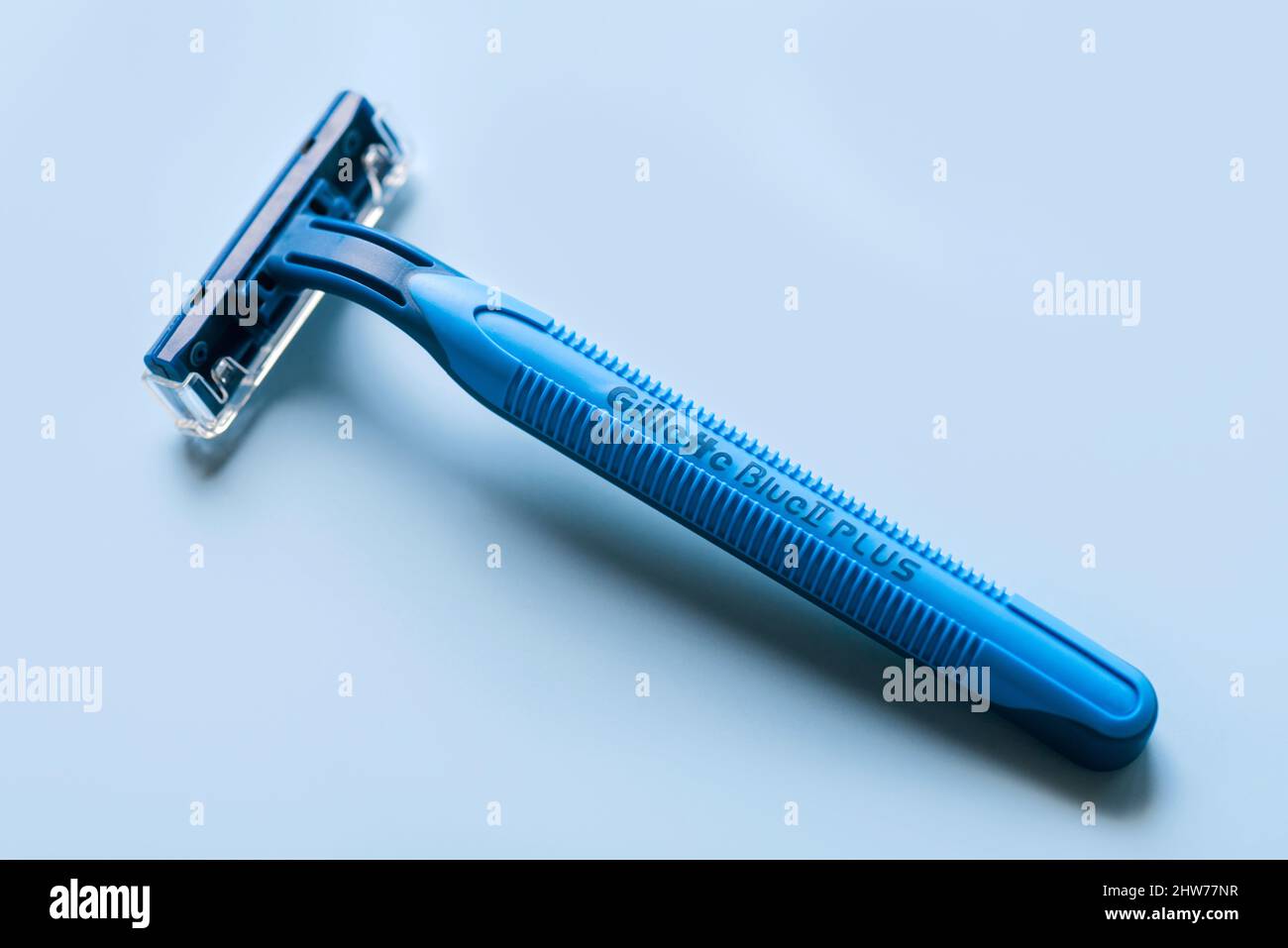 Closeup of Gillette Blue 2 razor Plus over blue background Stock Photo