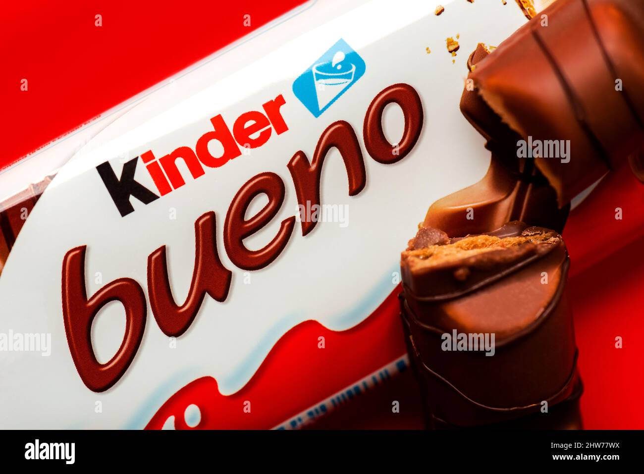 Closeup of package of Kinder bueno and Kinder Bueno milk chocolate bar over red background Stock Photo