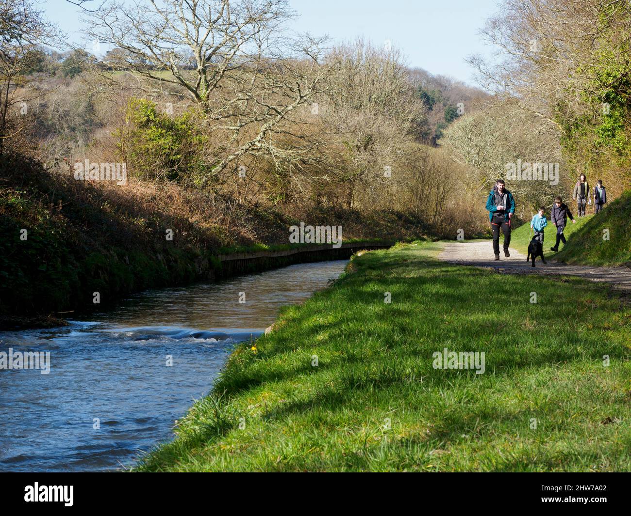 Family walking along the St Austell River during the February half term, Pentewan, Cornwall, UK Stock Photo
