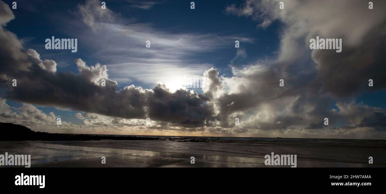 Freshwater West Bay, Pembrokeshire Wales with sky reflected in the strand clouds  blue sky Atlantic ocean Stock Photo