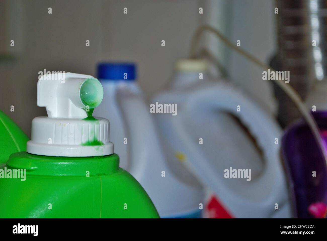 Closeup of laundry detergent fabric softener bleach and dryer sheets in a basement laundry room Stock Photo
