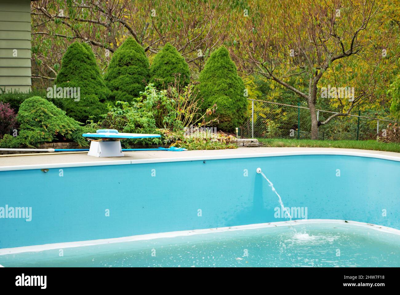 backyard swimming pool with diving board emptied out shutting down for ...