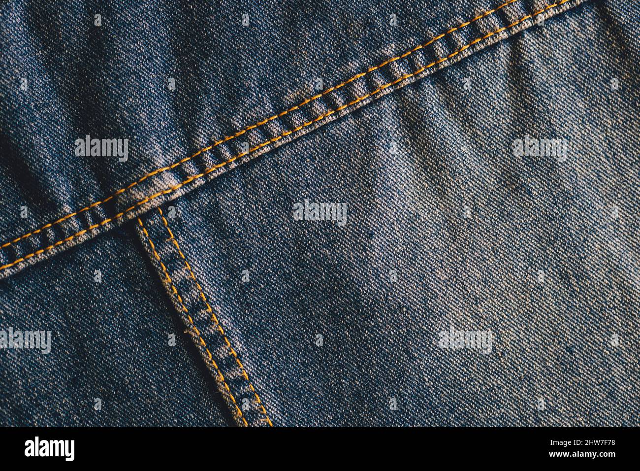 Fashionable denim with stitching. Textile material. Empty surface with space to copy. Part of clothes. View from above. Stock Photo