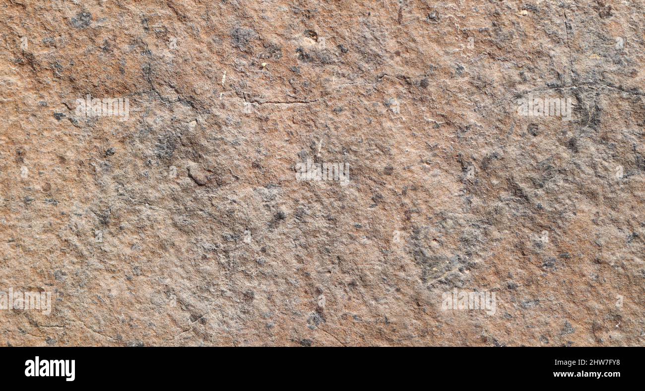 Brown colored stone detail texture abstract background. Stock Photo