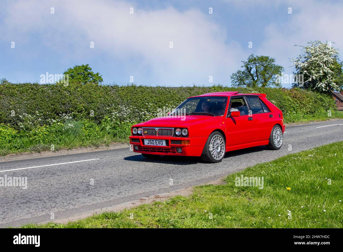 1992 90s nineties red Lancia Delta HF Integrale 1995cc petrol 4d en-route to Capesthorne Hall classic May car show, Cheshire, UK Stock Photo