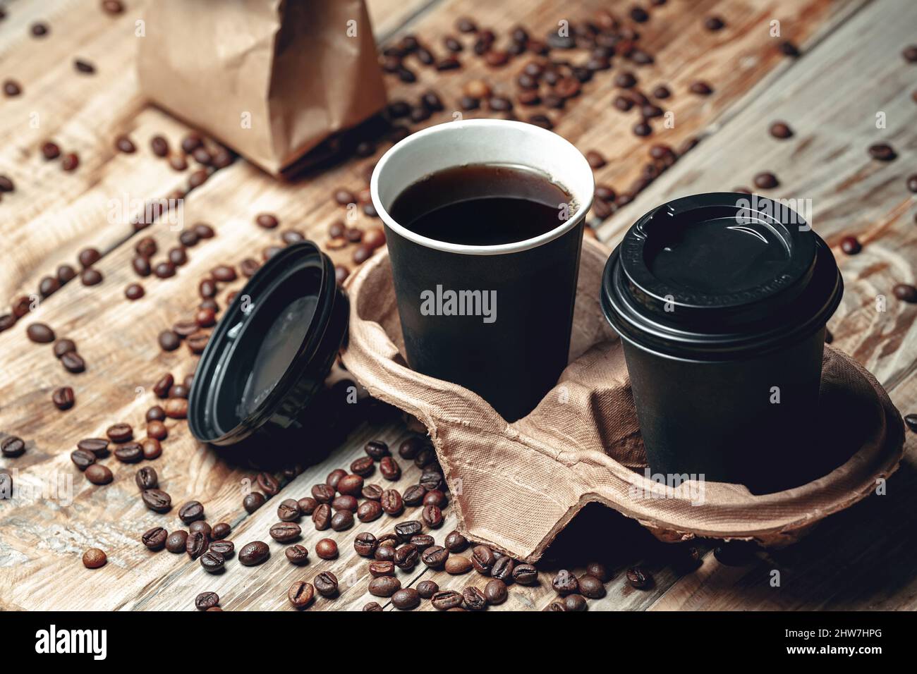 take away coffee cup and coffee beans on wooden background Stock Photo