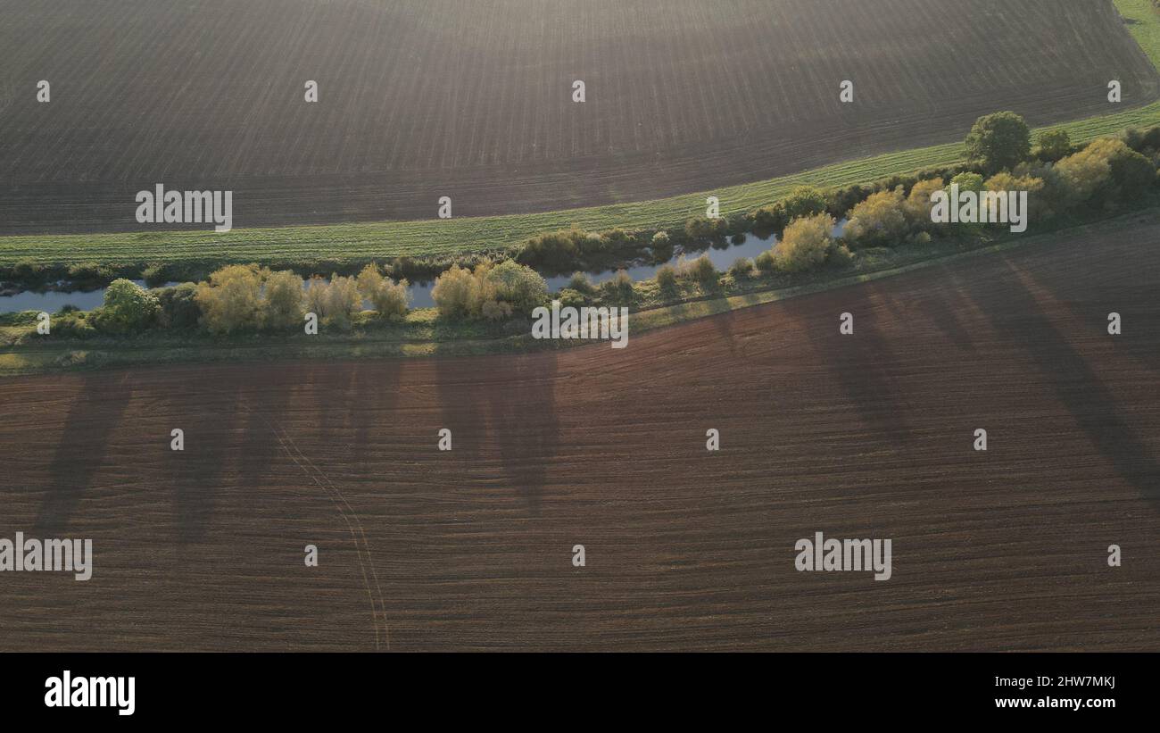 Aerial view of a river flowing on the field Stock Photo - Alamy