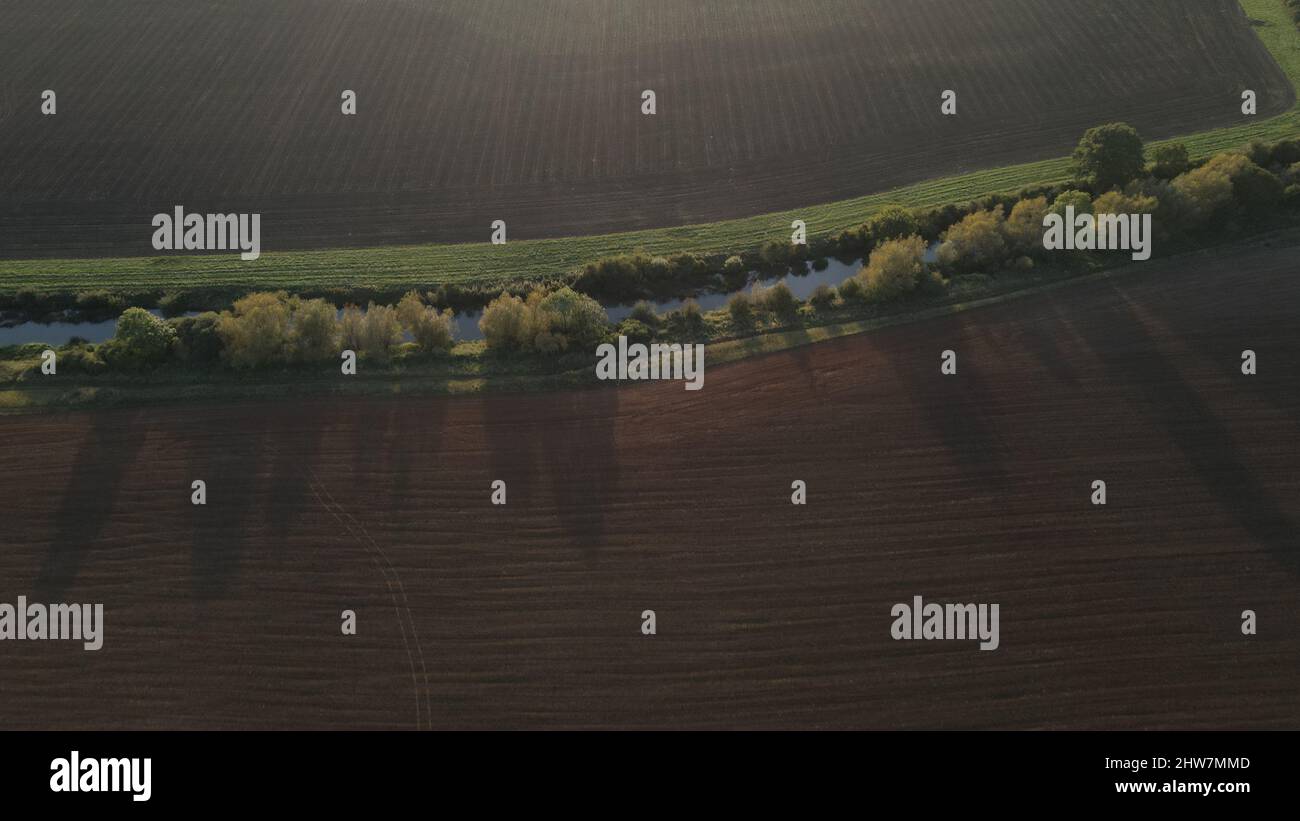 Aerial view of a river flowing on the field Stock Photo - Alamy