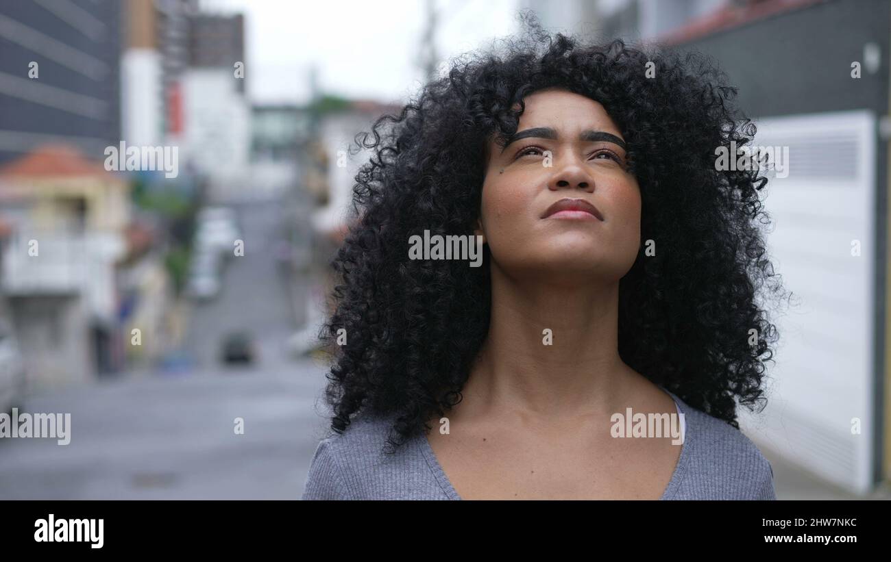 A young black woman looking up at sky with HOPE and FAITH Stock Photo ...
