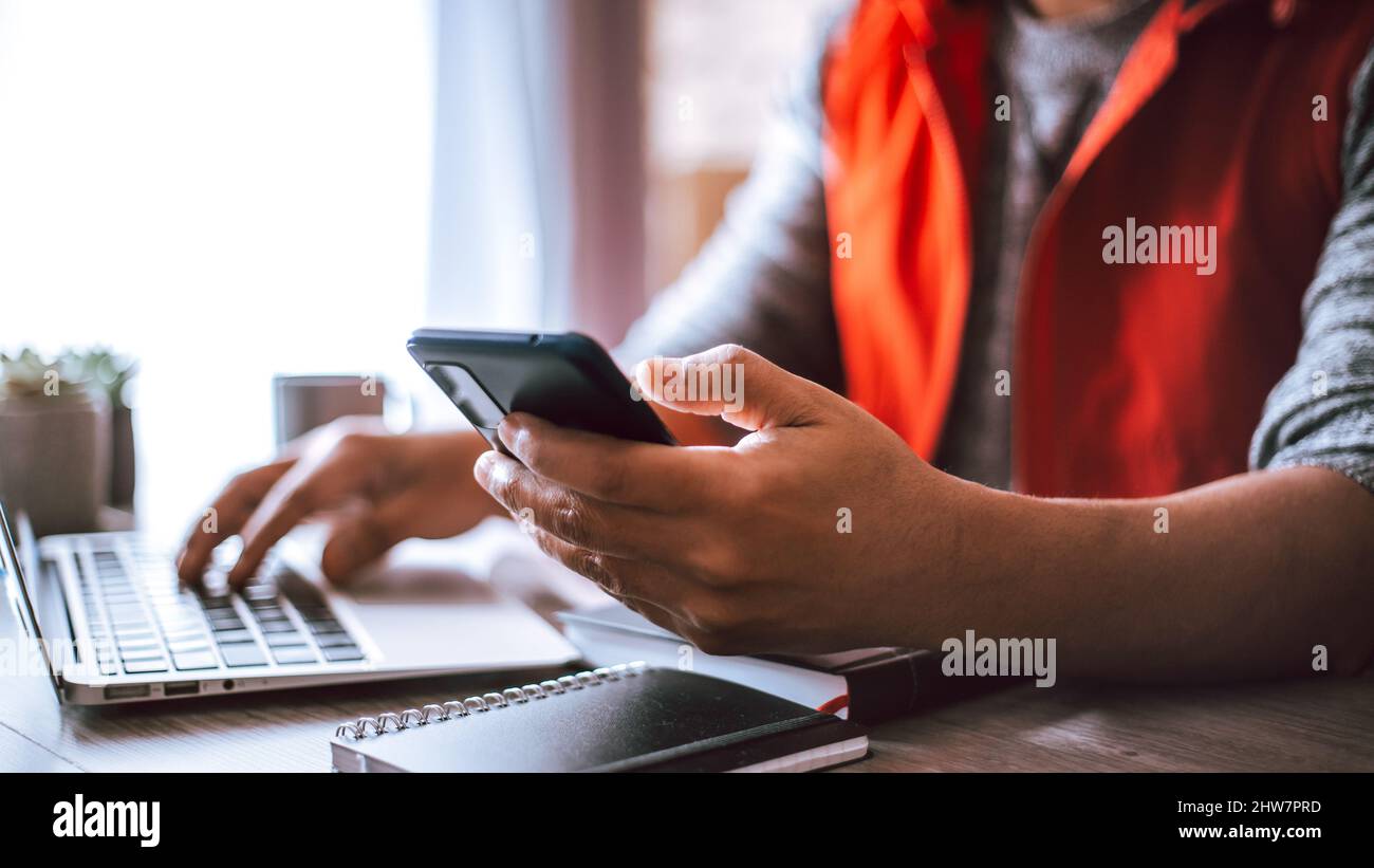 Young architect working in his office using his smart phone Stock Photo