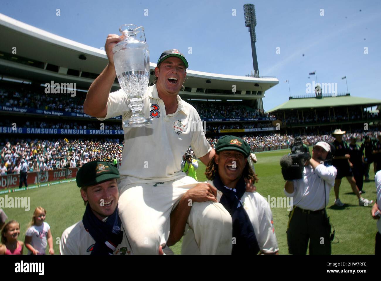 File photo dated 05-01-2007 of Australia's Shane Warne is carried around the field with the official Ashes Trophy by Michael Clarke and Andrew Symonds (right) after defeating England on the fourth day of the fifth Test match at the SCG in Sydney, Australia. Former Australia cricketer Shane Warne has died at the age of 52, his management company MPC Entertainment has announced in a statement. Issue date: Friday March 4, 2022. Stock Photo