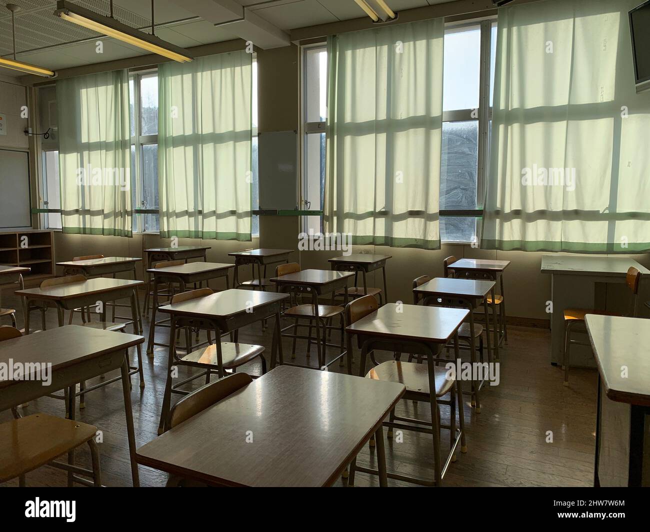 Japanese public school classroom with wooden chairs and desks. Stock Photo