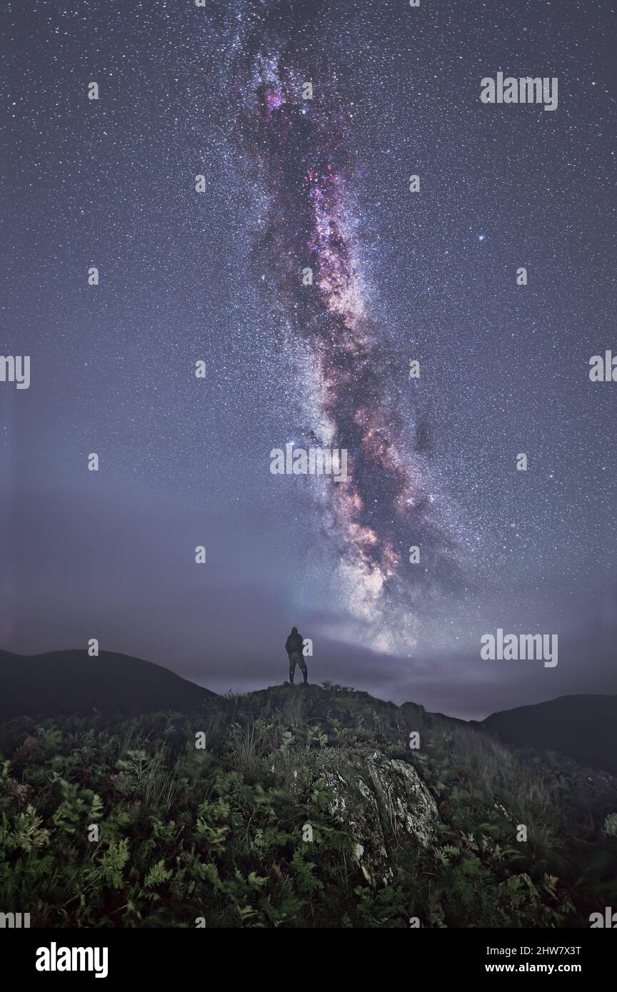 Silhouette of a man looking with amazement at the night sky with the Milky Way Stock Photo