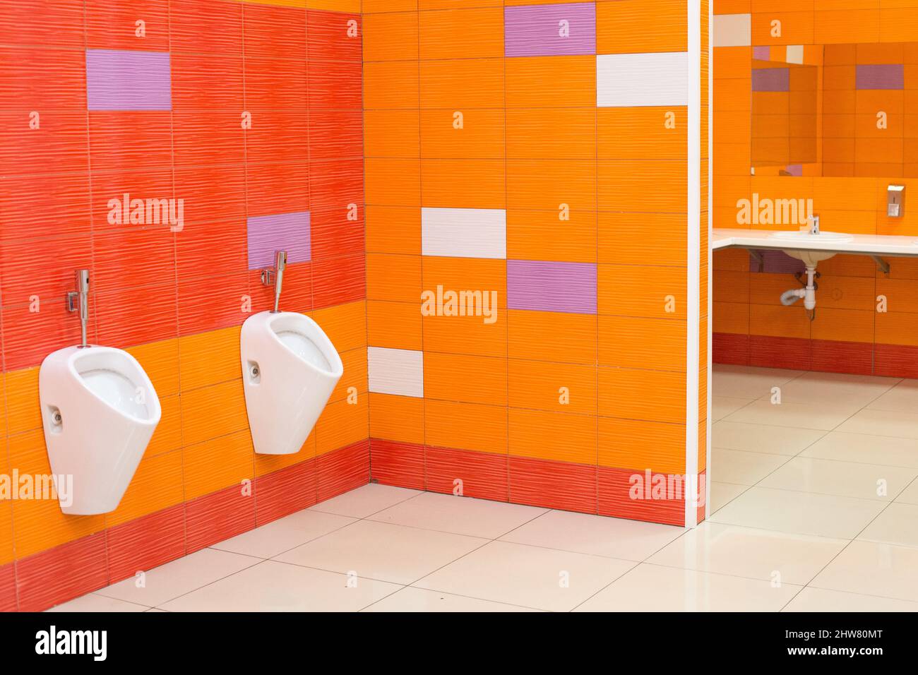 Bright creative public toilet design in yelloworange color Stock Photo