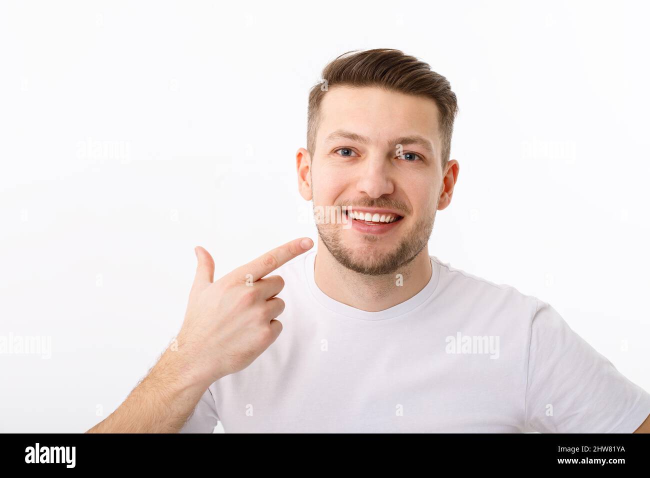 The smile of a young man in close-up. The result of teeth whitening ...