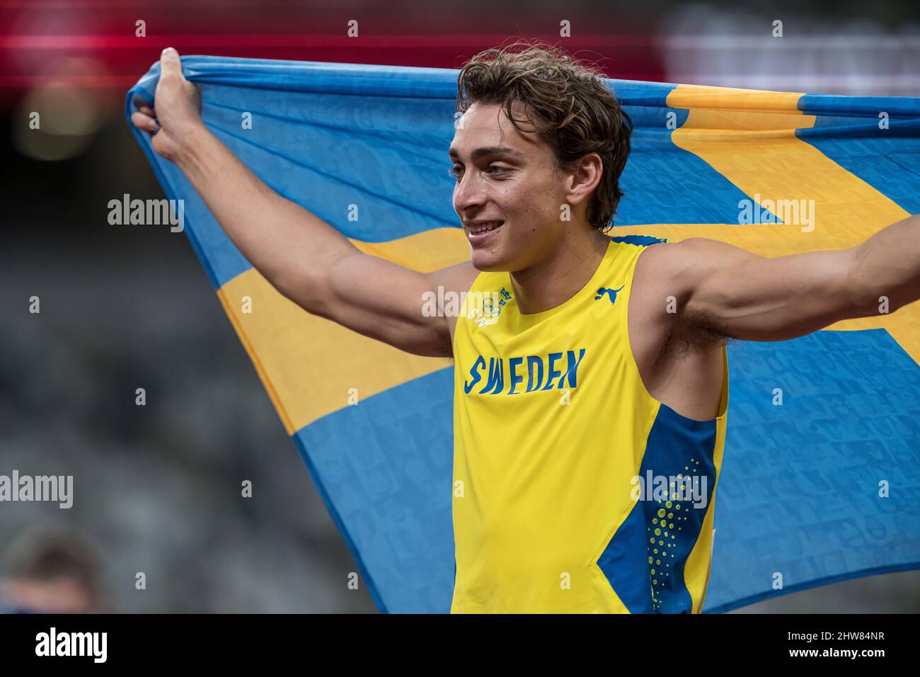 Mondo Duplantis Celebrating His Victory With His Country s Flag At The mondo-duplantis-celebrating-his-victory-with-his-country-s-flag-at-the