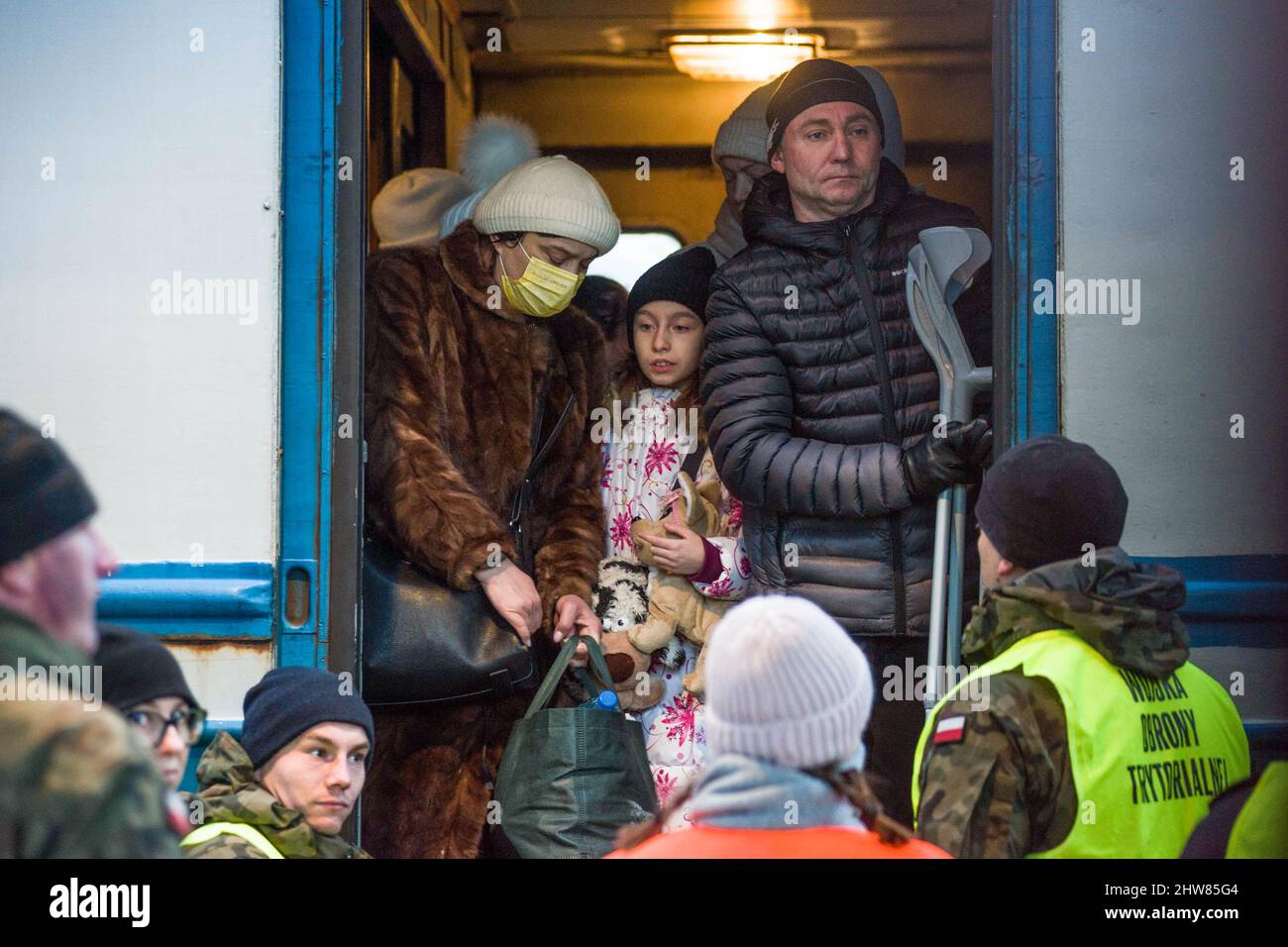 Przemysl, Poland. 03rd Mar, 2022. Ukrainian citizens look out from the train that arrived from Ukraine to Przemysl train station. On the 8th day of the Russian invasion in Ukraine thousands of exhausted refugees fleeing war are arriving to the Polish border town of Przemysl. Credit: SOPA Images Limited/Alamy Live News Stock Photo
