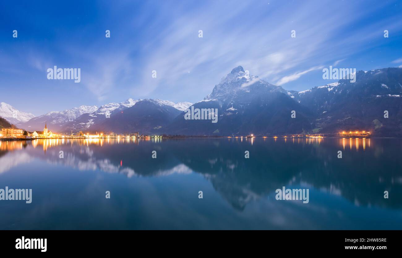 Night landscape. A small town in the Swiss Alps. Stars in the night sky. Stock Photo