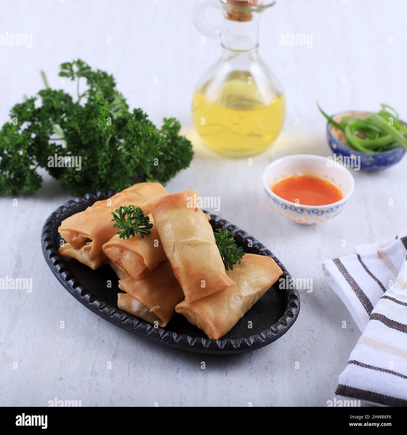 Homemade Spring Roll (Lumpia), Stuffed with Chicken and Shrimp, Served with Sour and Sweet Sauce, on White Table Stock Photo