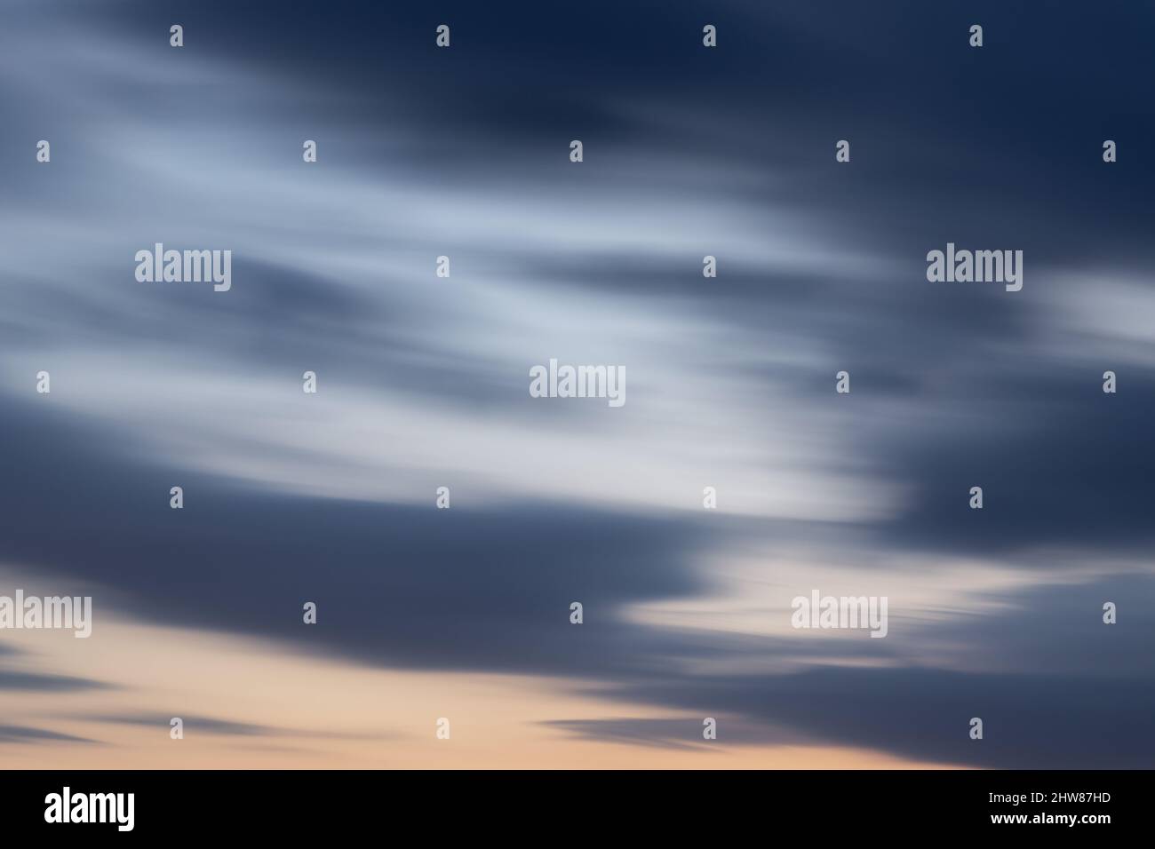 Sky with abstract clouds at dusk - background in long exposure Stock Photo