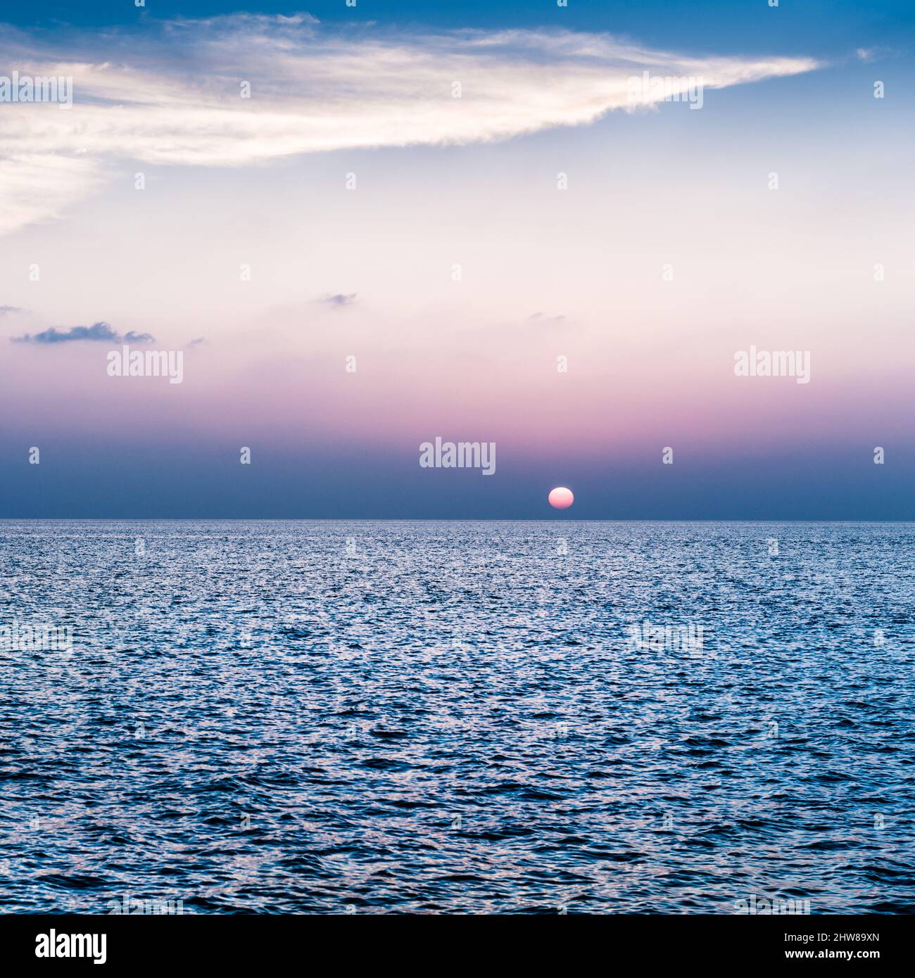 Sun Ball sunset in the ocean on the horizon. Maldives. Book cover Stock ...