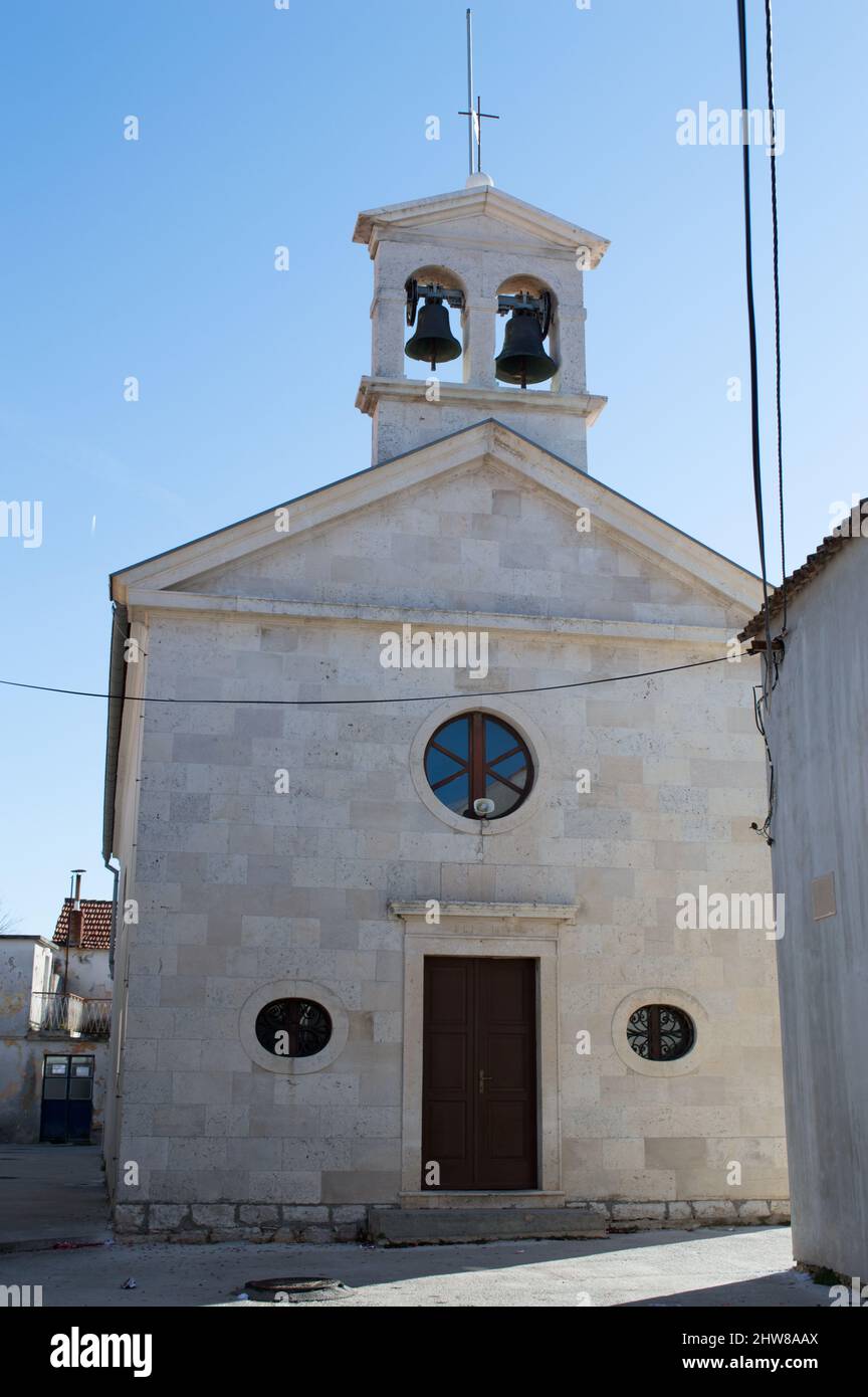 Historic catholic Church of Saint Roch in the village Bibinje near Zadar in Croatia, with characteristic bell tower with two bells Stock Photo