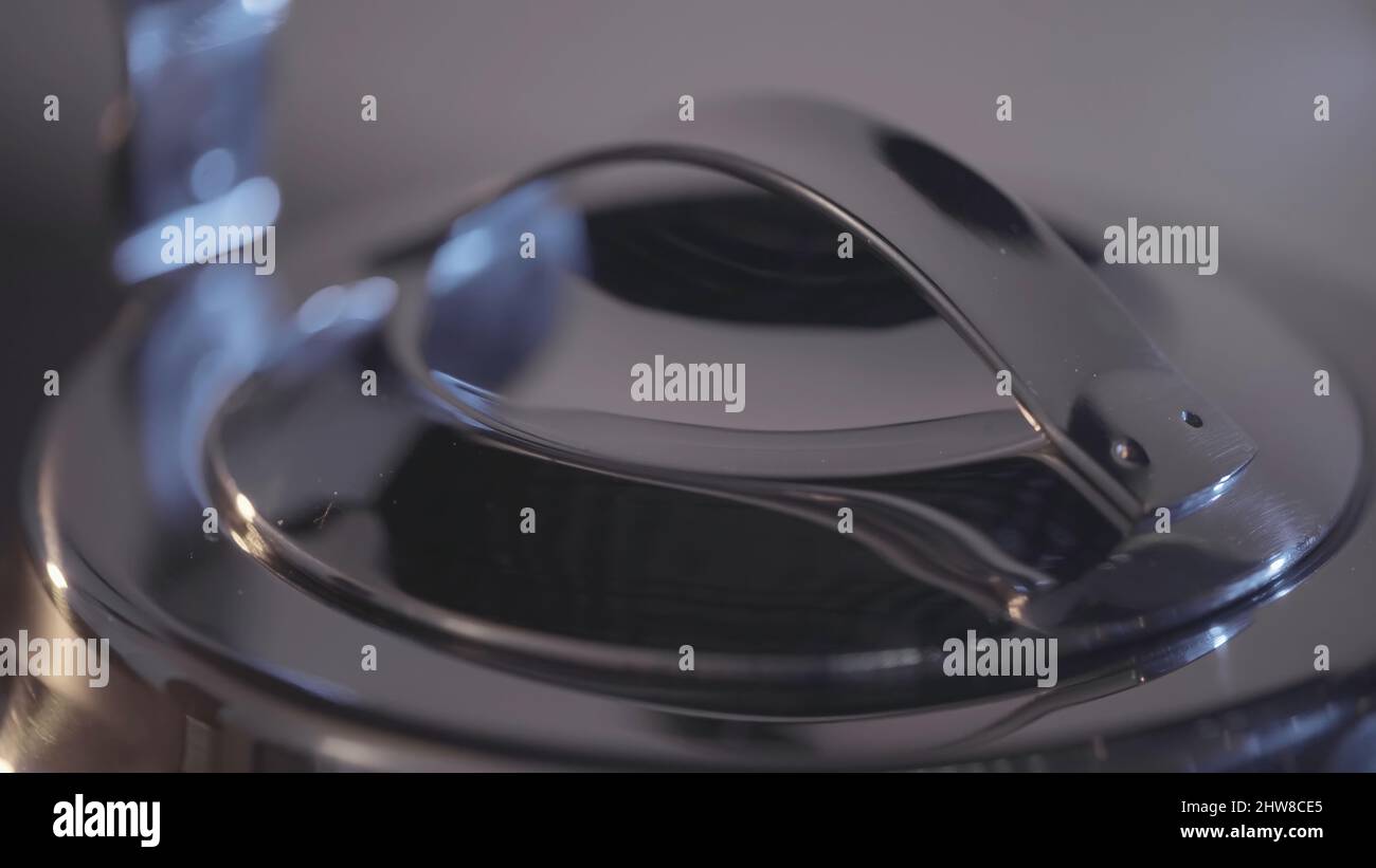Lid of metal teapot. Action. Closeup of beautiful metal parts of