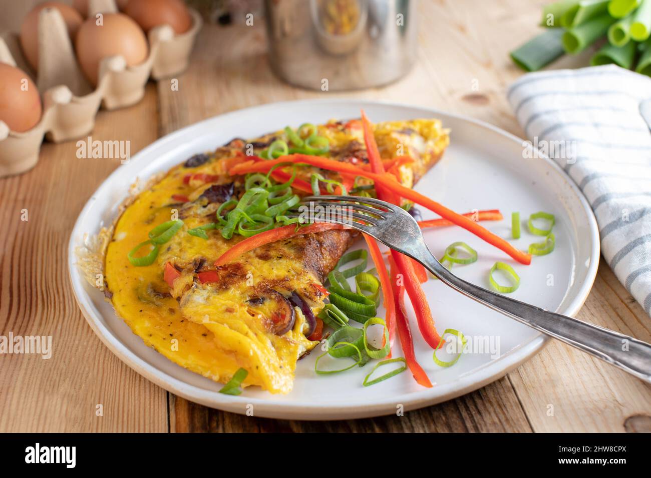 Omelette with bell peppers, onions and chives. Healthy protein breakfast for low carb or ketogenic diet Stock Photo