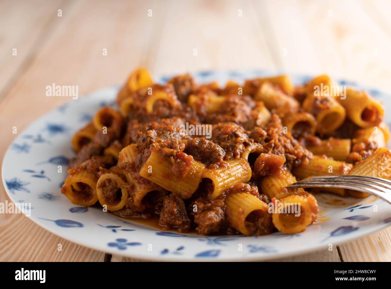 Rigatoni or penne with bolognese sauce on a plate. Closeup Stock Photo