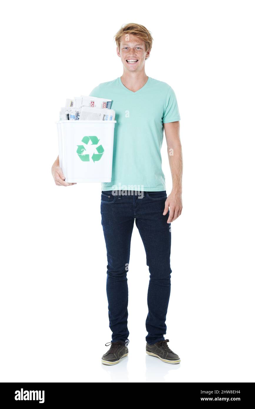 Lets recycle. A friendly young red-headed man holding a recycling bin filled with newspapers. Stock Photo