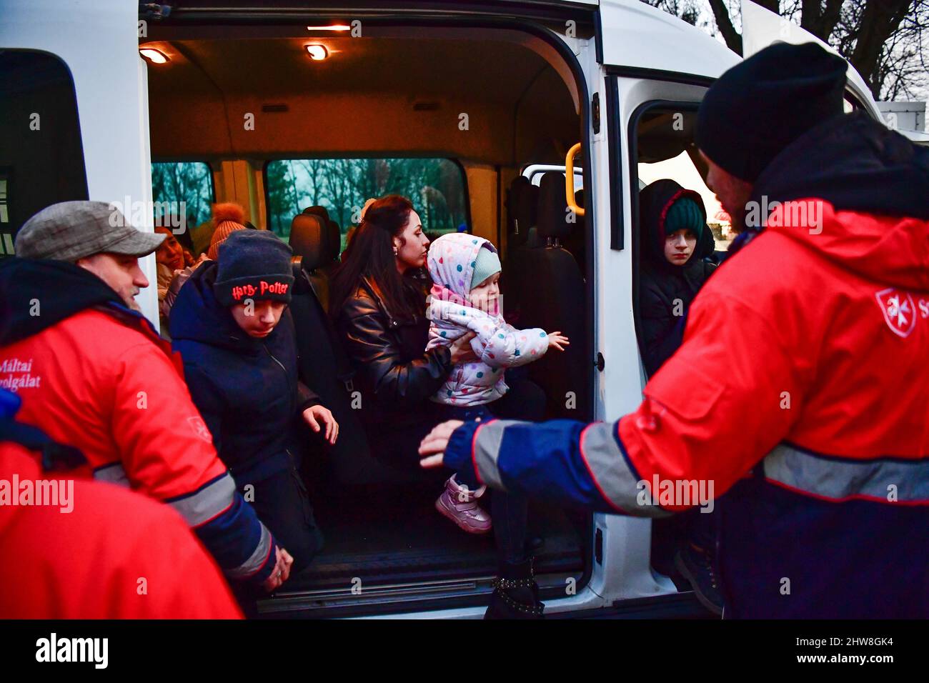 04 March 2022, Hungary, Beregsurány: Refugees from the Ukrainian sit in a car near a refugee shelter run by the Order of Malta. Photo: Marton Monus/dpa Stock Photo