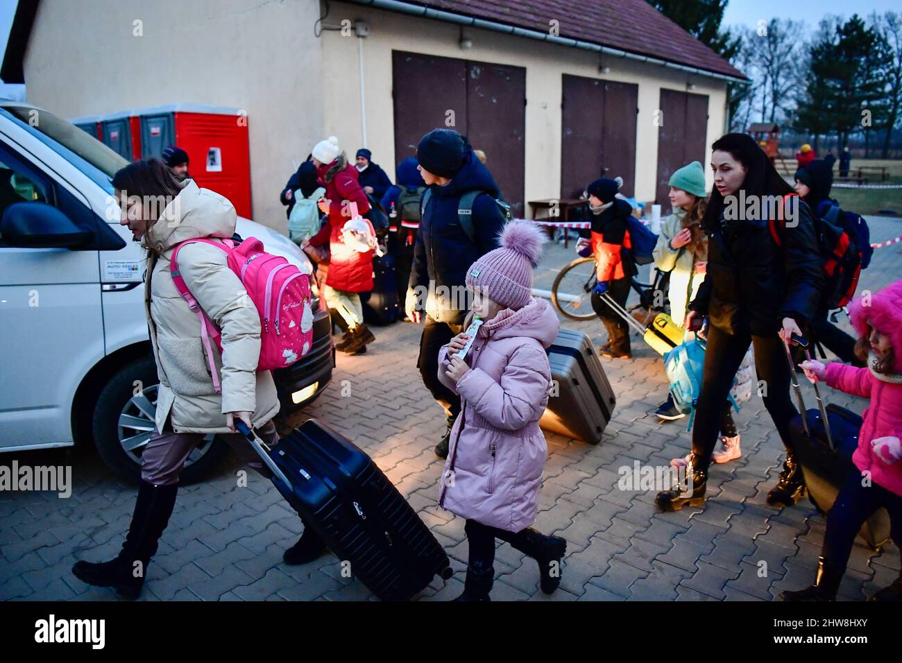 04 March 2022, Hungary, Beregsurány: Refugees from the Ukrainian go to a car near a refugee shelter run by the Order of Malta. Photo: Marton Monus/dpa Stock Photo