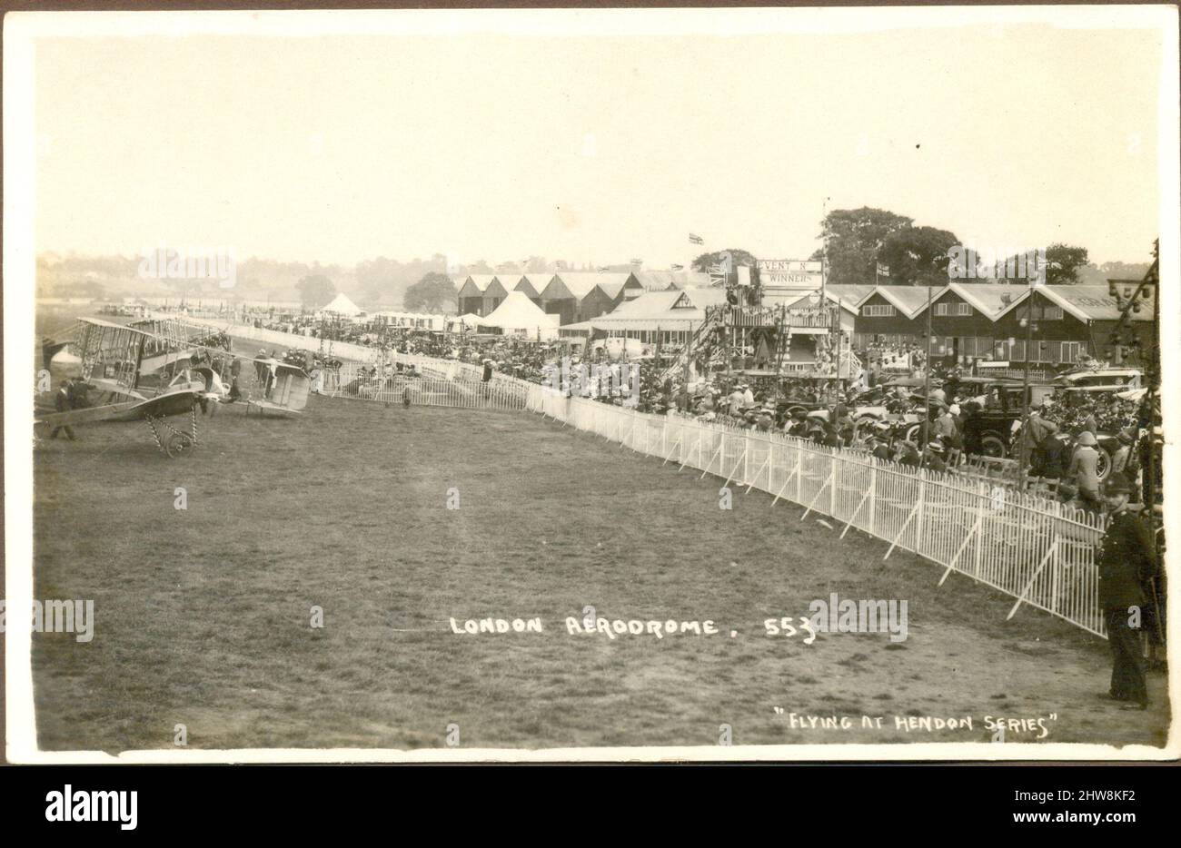 Photographic postcard of London Aerodrome with fairground crowds looking at display of aircraft circa 1912 Stock Photo